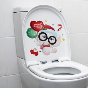 Detail of Christmas snowman elephant sticker on white toilet lid for bathroom decor