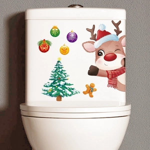 Detail of waterproof Christmas reindeer and tree stickers on white toilet tank