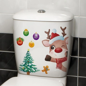 Macro shot of waterproof Christmas reindeer and snowman stickers on a white toilet tank
