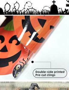 Close-up of double-side printed Halloween window clings featuring pumpkins and spiders