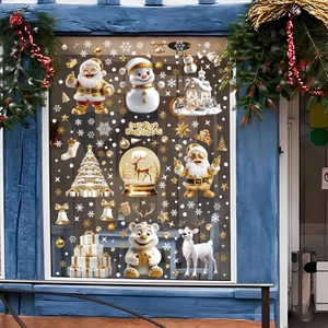 Christmas window decals with gold snowman and white bear stickers on a blue glass window