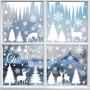 White Christmas window stickers featuring reindeer, snowflakes and trees on a glass pane