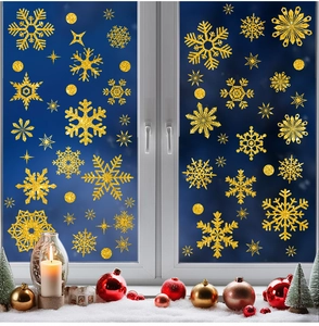 Detail of gold glitter snowflake window stickers with festive Christmas decor and candles