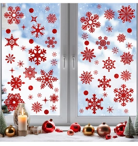 Detail of red glitter snowflake window decals with a snowy winter window background