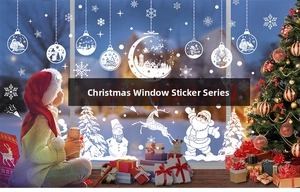 Detailed view of white Christmas window decals with Santa Claus and snowflakes on glass