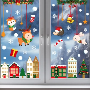 Detail of Christmas window stickers featuring cartoon animals and snowy forest scenery