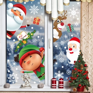 Close-up of Santa and reindeer stickers on a window with a snowy winter background