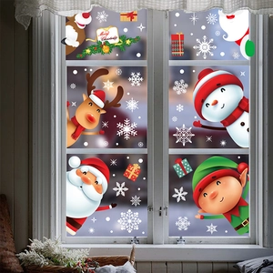 Cartoon Christmas window clings featuring Santa Claus and reindeer on glass pane