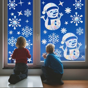 Rainbow prism Christmas window clings featuring snowmen and snowflakes on glass