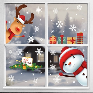 Christmas window decals with reindeer, snowman, and snowflakes on a snowy forest backdrop