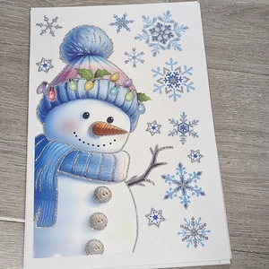 Detail of blue glitter snowman and snowflake window stickers for Christmas party decor