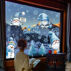 Detailed blue Christmas window decals featuring gnomes and snowmen with snowy mountain view