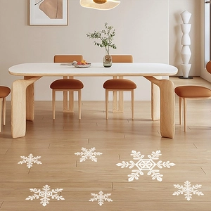 Detail of white snowflake window clings on minimalist wooden flooring for winter decor