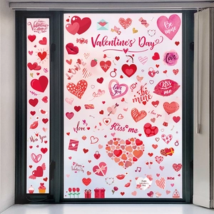 Detail view of Valentine heart stickers and red balloons on a bright home window