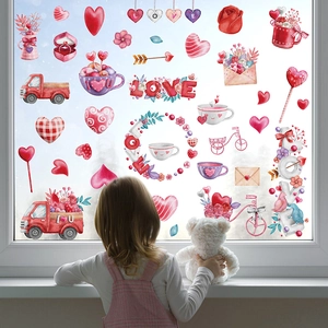 Valentine window clings set with watercolor hearts and love motifs on a glass window