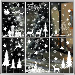 White Christmas window decals featuring Santa, reindeer, and snowflakes on glass pane