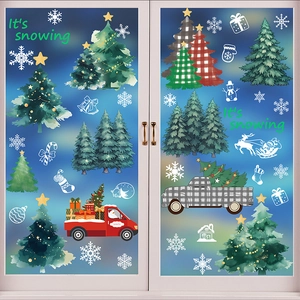 Christmas window stickers with festive red trucks and snowmen on glass panel