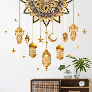 Detail of gold Ramadan wall stickers with mandala, moon and lanterns on white wall