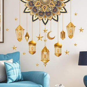 Detail of golden Ramadan moon and lanterns wall sticker on a blue living room wall
