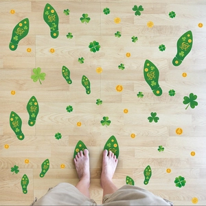 Detail of St. Patrick's Day shamrock and lucky footprints floor decals on wooden surface