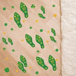Detail of St. Patrick's Day green footprint floor stickers with shamrock on wood surface