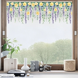 Detail of floral window film with yellow roses and purple flowers on glass