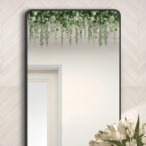 Detail view of mirror with white rose floral vine decoration and minimalist black frame