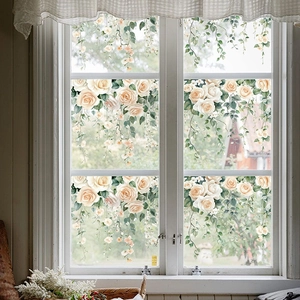 White rose and vine static cling window stickers on a wooden frame glass window