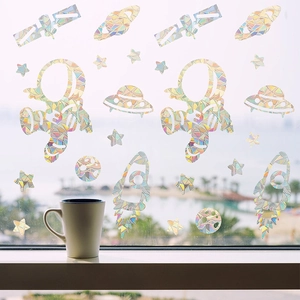Detailed holographic astronaut and planet window decals showing rainbow light refraction
