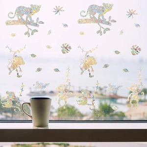Rainbow monkey window stickers with leaves showing colorful prismatic refraction