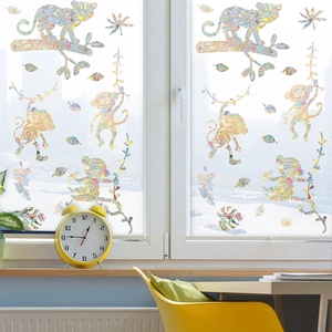 Detailed view of monkey and tropical leaf patterns on colorful glass window film decal
