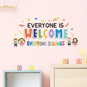 Detail of colorful 'Everyone is Welcome' classroom wall decals on a pink wall