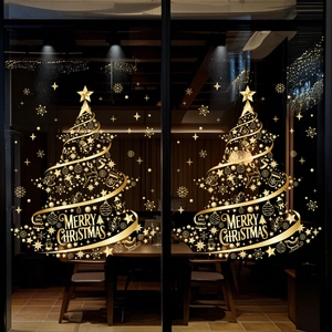 Close-up of golden Christmas tree window stickers with stars and Merry Christmas text