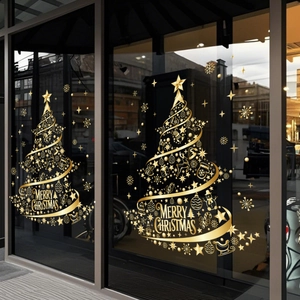 Detail of golden Christmas tree window decals with snowflake and reindeer motifs