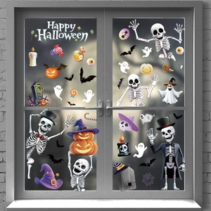 Close-up of Halloween window decals featuring pumpkins and skeletons on glass door