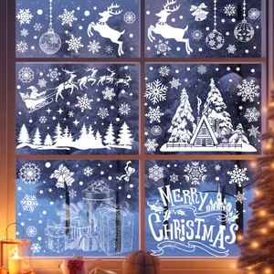 White Christmas window decals with Santa, reindeer and snowflakes on glass window