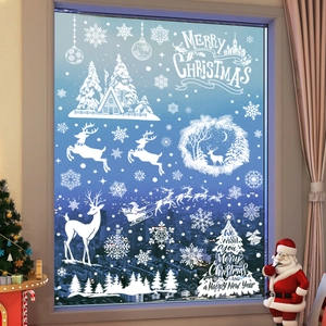 White Christmas window decals with snowflakes and Santa sleigh on glass background