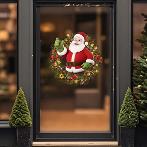 Dettaglio adesivo Babbo Natale al centro di una ghirlanda di pino su porta in vetro