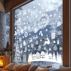 White Christmas window decals with reindeer, snowflakes, and trees on a glass window