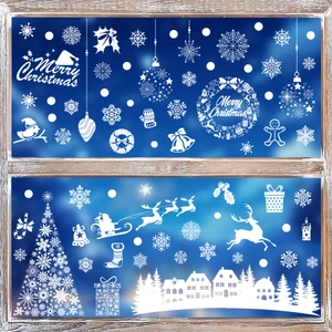 White Christmas window decals with reindeer, snowflakes and trees on a glass pane