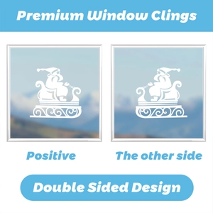 Double-sided white Christmas window cling showing Santa's sleigh design from both views