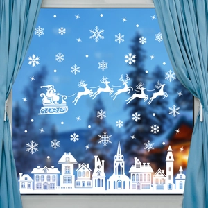 Close-up of white Christmas silhouette window stickers showing Santa and snowflakes