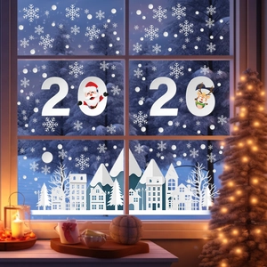 Close-up of white snowflake decals and reindeer silhouettes on a glass window