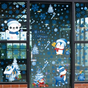 Close-up of blue Christmas window stickers featuring snowmen and snowflakes on glass door