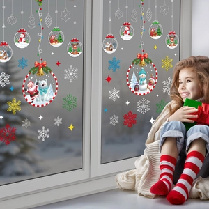 Close-up of colorful Christmas window clings with Santa Claus and snowflakes on glass