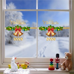 Detail view of Merry Christmas 2026 window stickers with bells and snowy window background