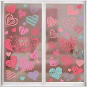 Detail of Valentine's Day window decals with heart patterns and Love text on glass
