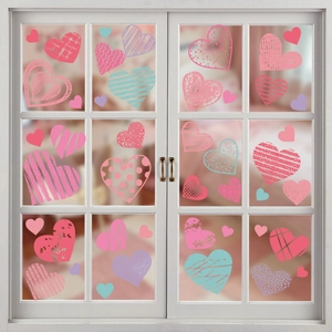 Detail of colorful heart window stickers with polka dots and stripes on a glass door