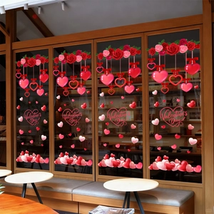 Valentine's Day window decals featuring red roses and heart pendants on a glass display