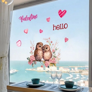Valentine's Day owl static window stickers on a bright window with a scenic sea view